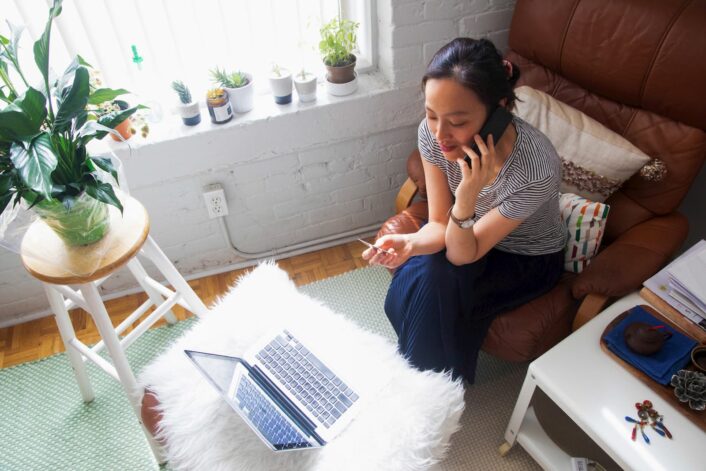 woman buys something on credit card with laptop