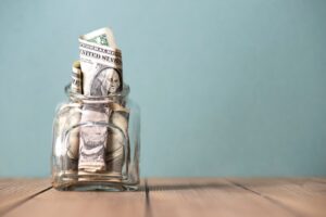 wad of cash stuffed into a jar to save for a rainy day