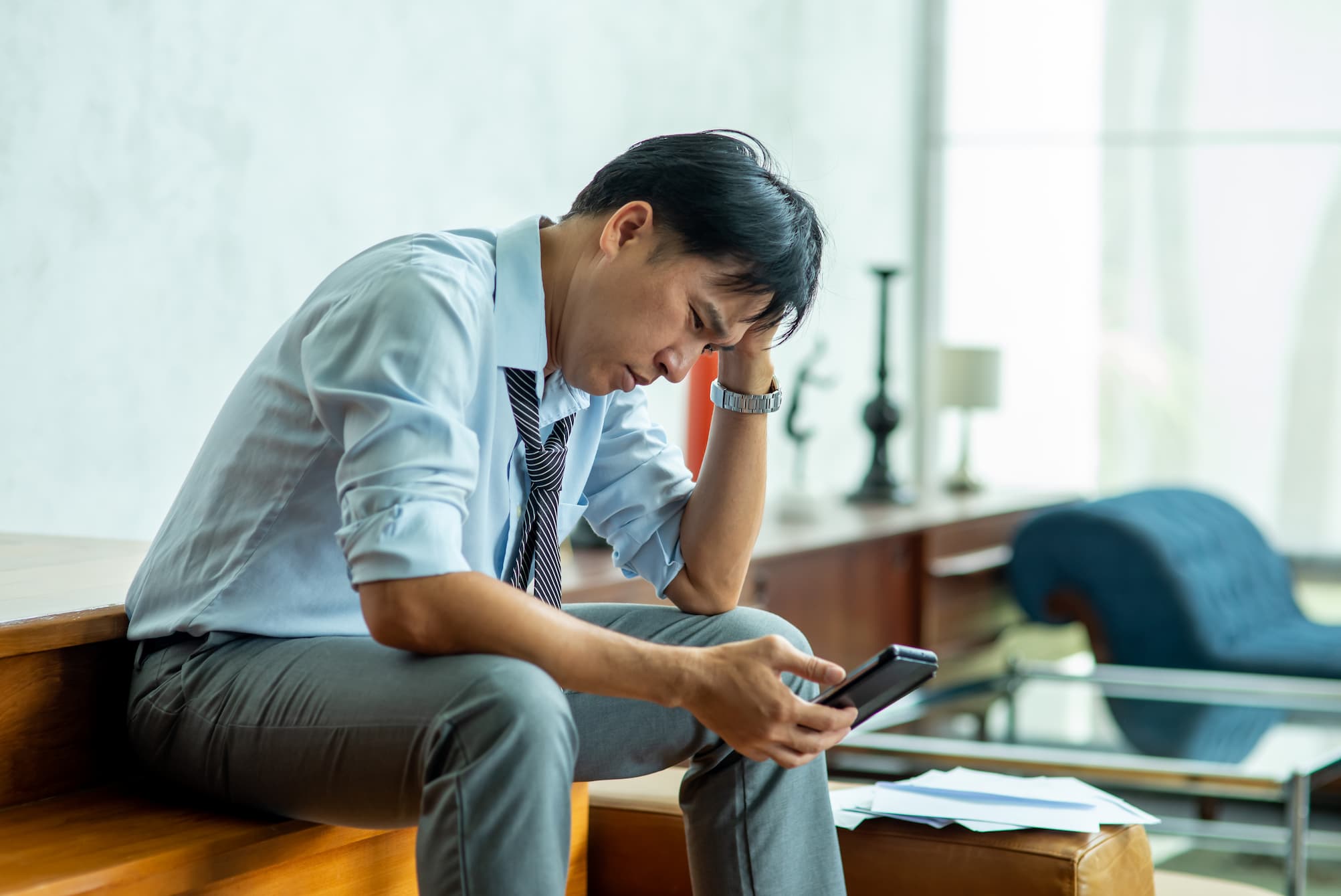 A man looking at his phone, trying to find his IP address