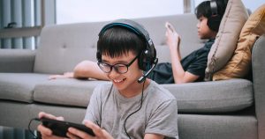 kids playing video games on the couch