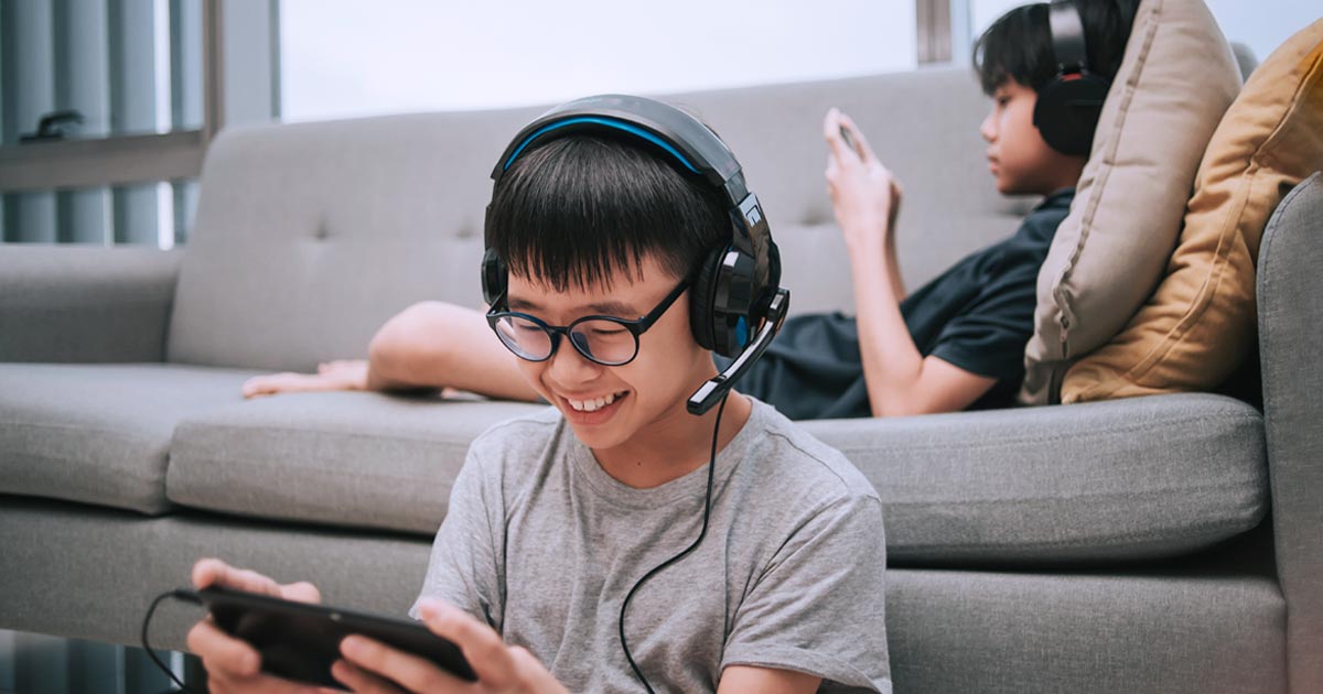 kids playing video games on the couch