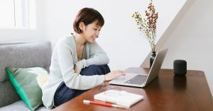 woman sitting and working at laptop