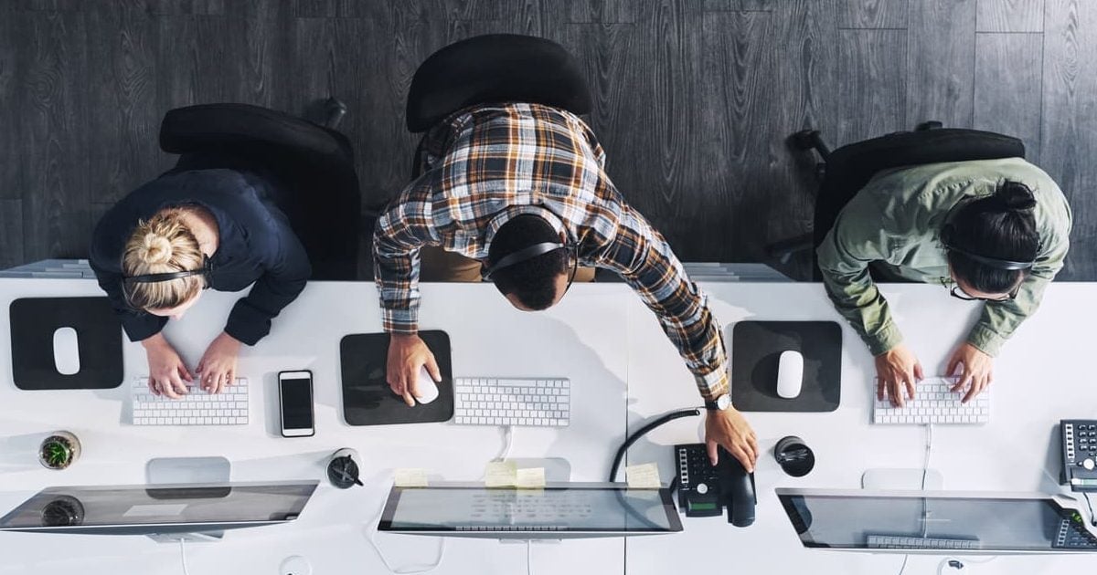 workers sitting at computers in an office