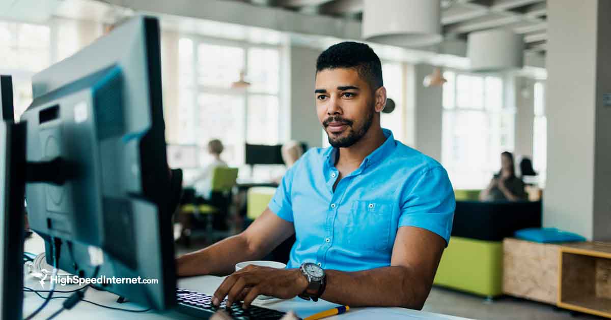 male looking at computer in office building