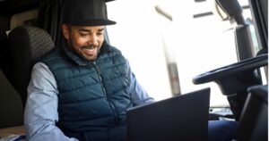 truck driver typing on laptop