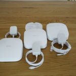 The three-pack kit includes three Eero Pro 6 units, three power adapters, and an Ethernet cable.