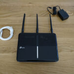 The TP-Link Archer A10 ships with an Ethernet cable and a power adapter.
