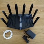 The TP-Link Archer AX90 ships with an Ethernet cable and a power adapter.