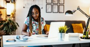 african american woman using her laptop to study