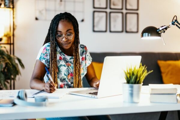 african american woman using her laptop to study