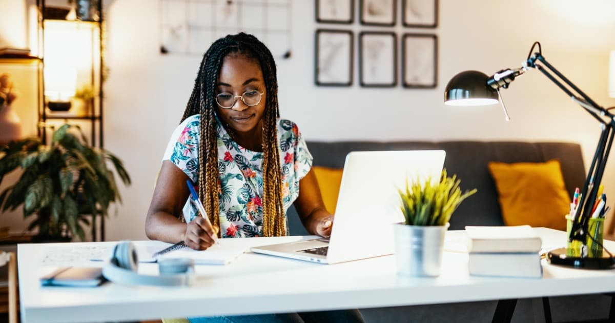 african american woman using her laptop to study