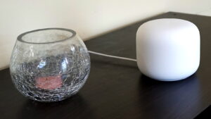 Google Nest Wifi on counter next to small glass bowl