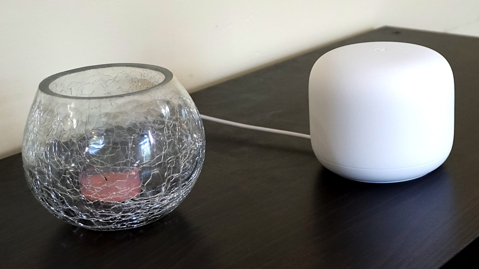 Google Nest Wifi on counter next to small glass bowl