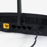 Rear of NETGEAR R6700AX router showing four LAN ports and one WAN port