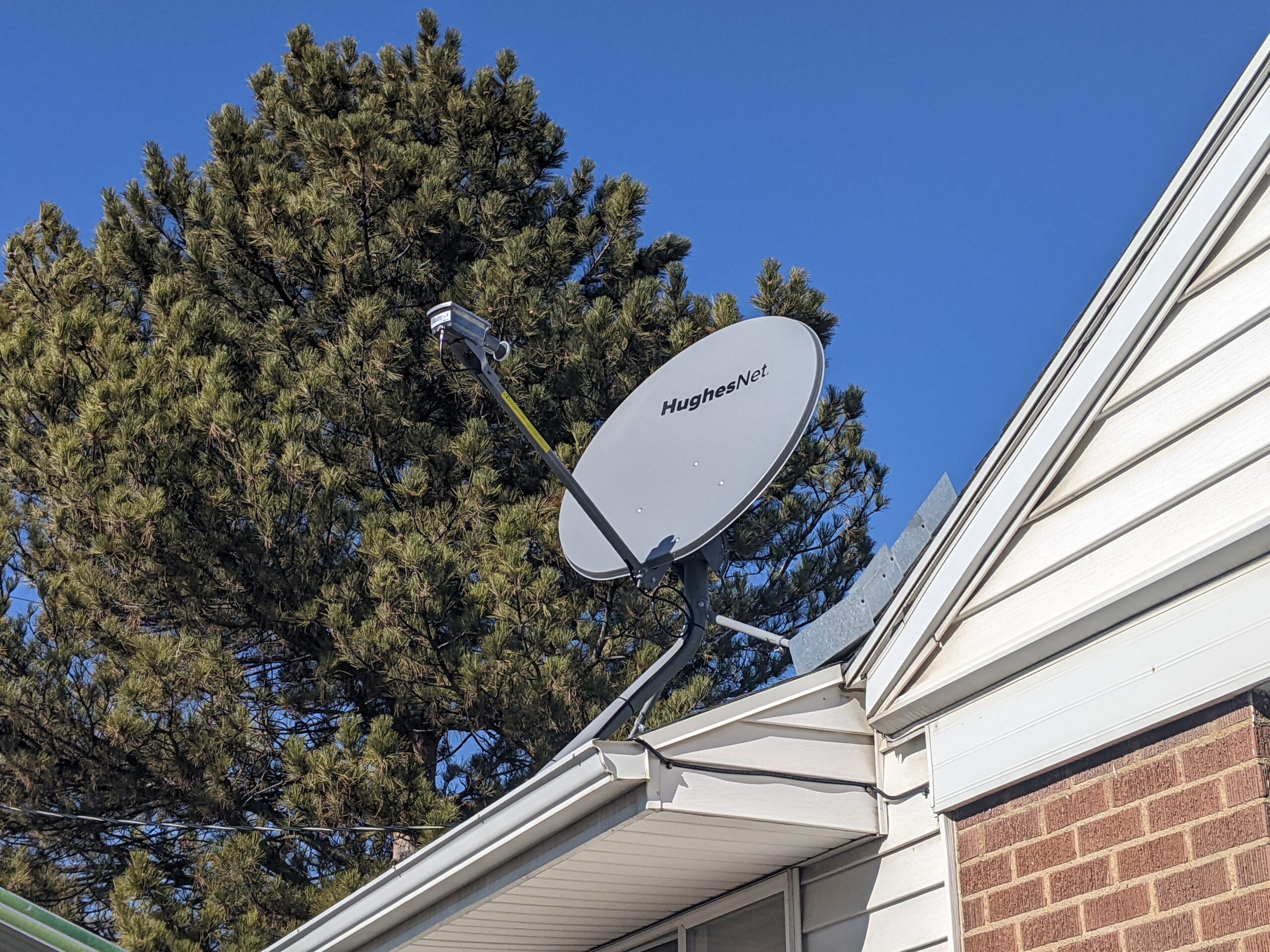 HughesNetInstallation1 HughesNet satellite dish mounted on top of house