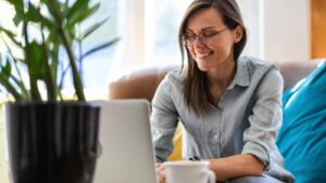 woman sitting at a computer and smiling