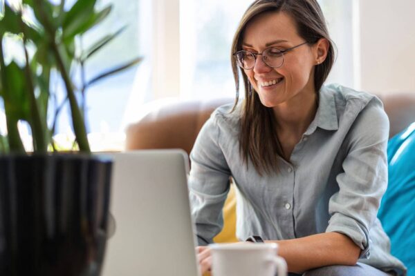 woman sitting at a computer and smiling