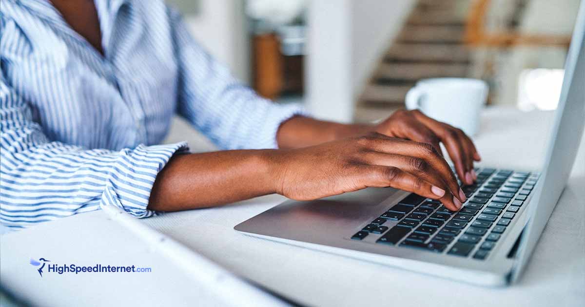 person typing on computer at home