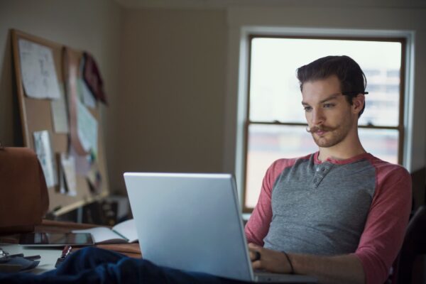 man-sitting-at-laptop-at-desk