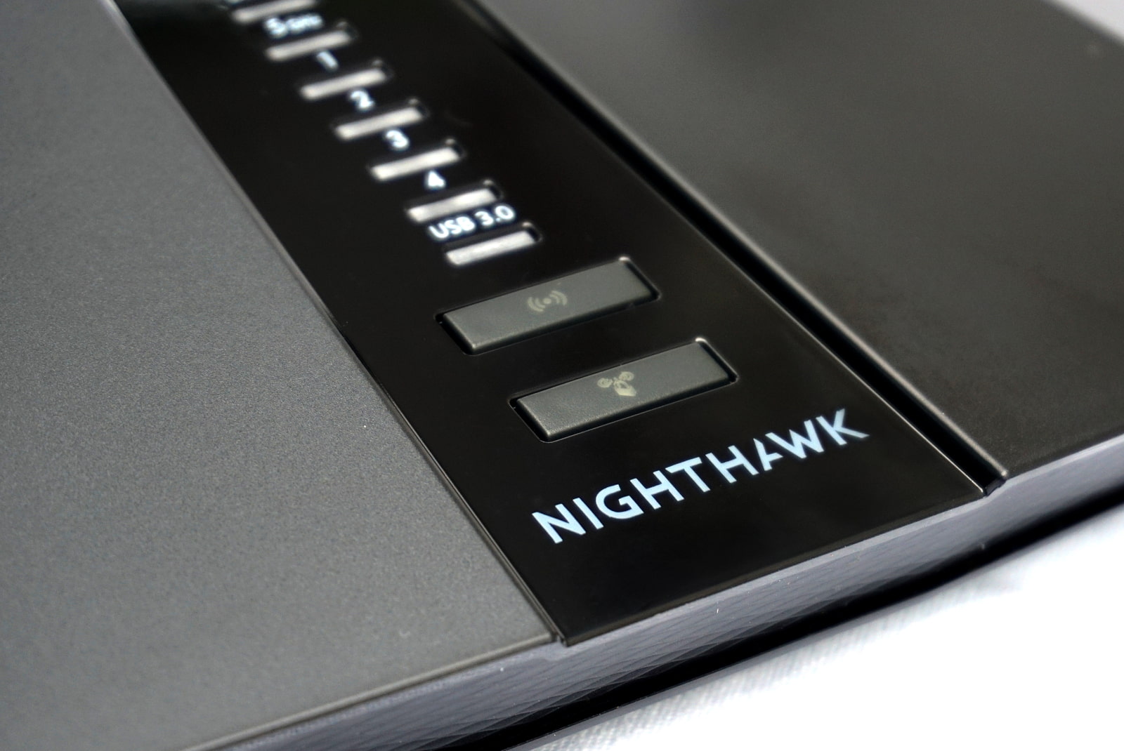 Close up of front of router showing Nighthawk logo and buttons
