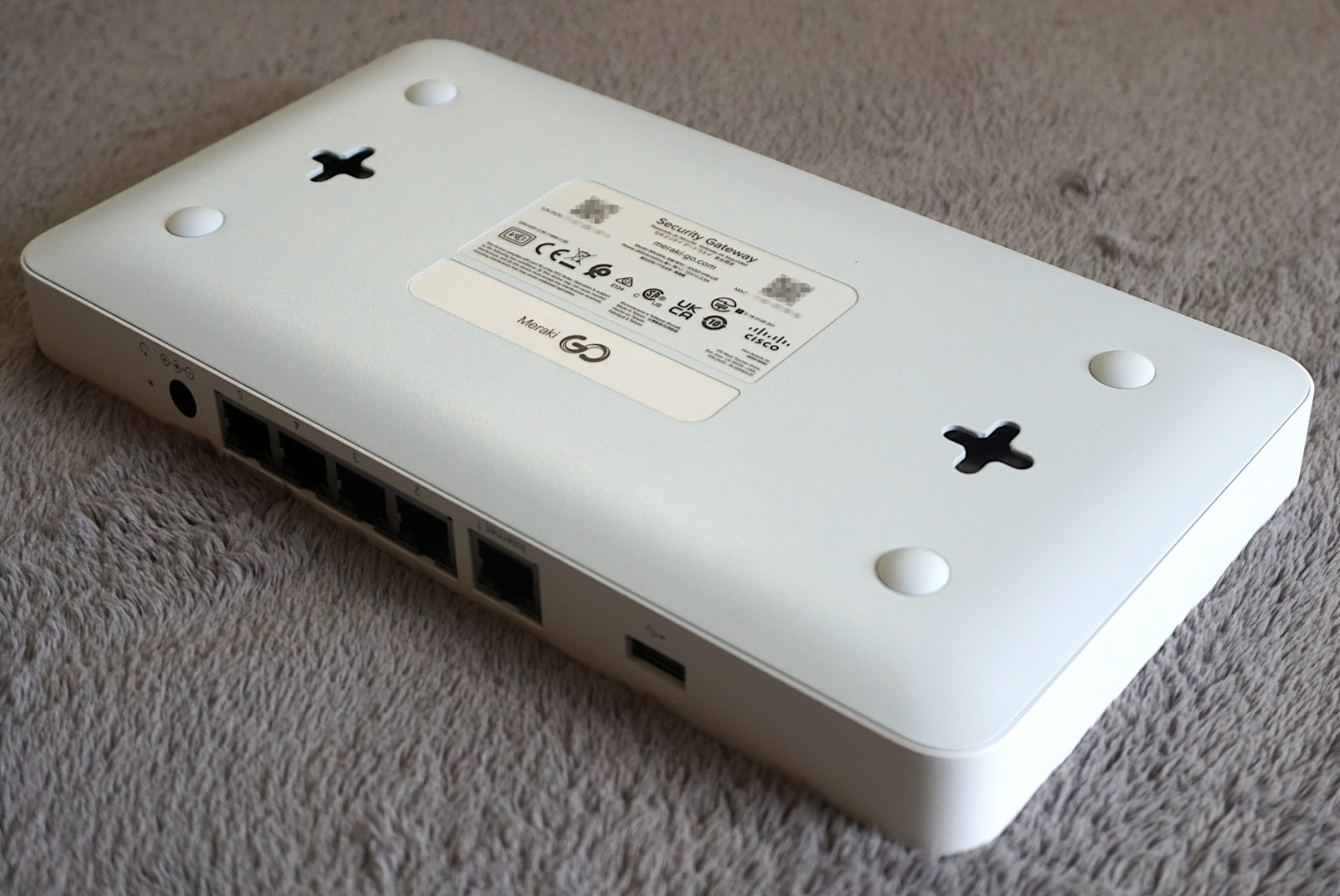 meraki-go-gx50-mounts Bottom of device shows wall mount brackets