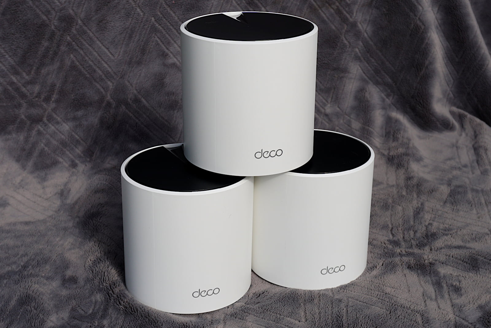 tplink-deco-x55-pro-stack-side Stack of three Deco X55 Pro units from the side