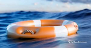 orange and white life raft floating in open water