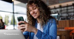 happy woman using cell phone to make a phone call over internet service