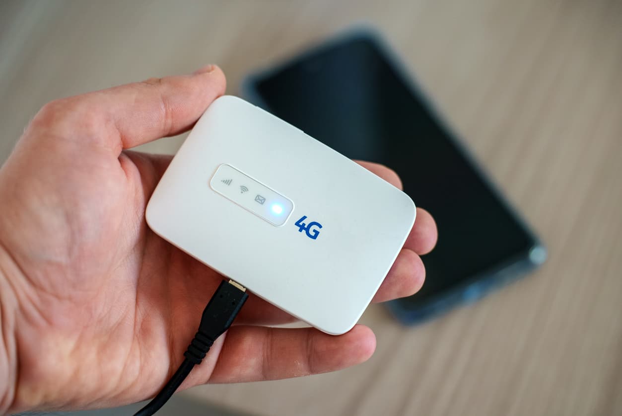 mobile-wifi-hotspot-compressed person holding a portable wifi hotspot