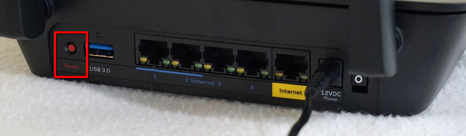 Reset button on far left of rear of Linksys router