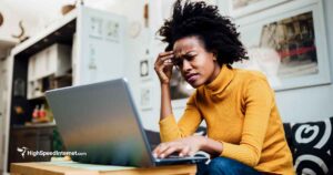 Woman appearing frustrated while looking at a laptop screen