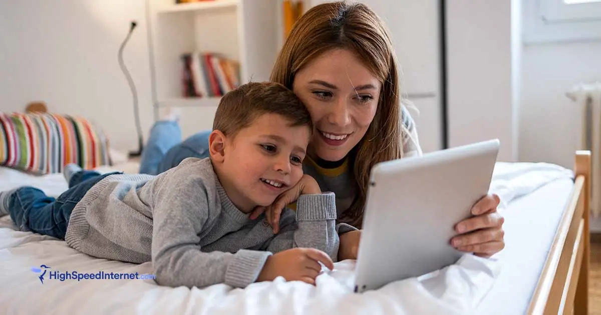 Mother and son looking at a tablet screen together