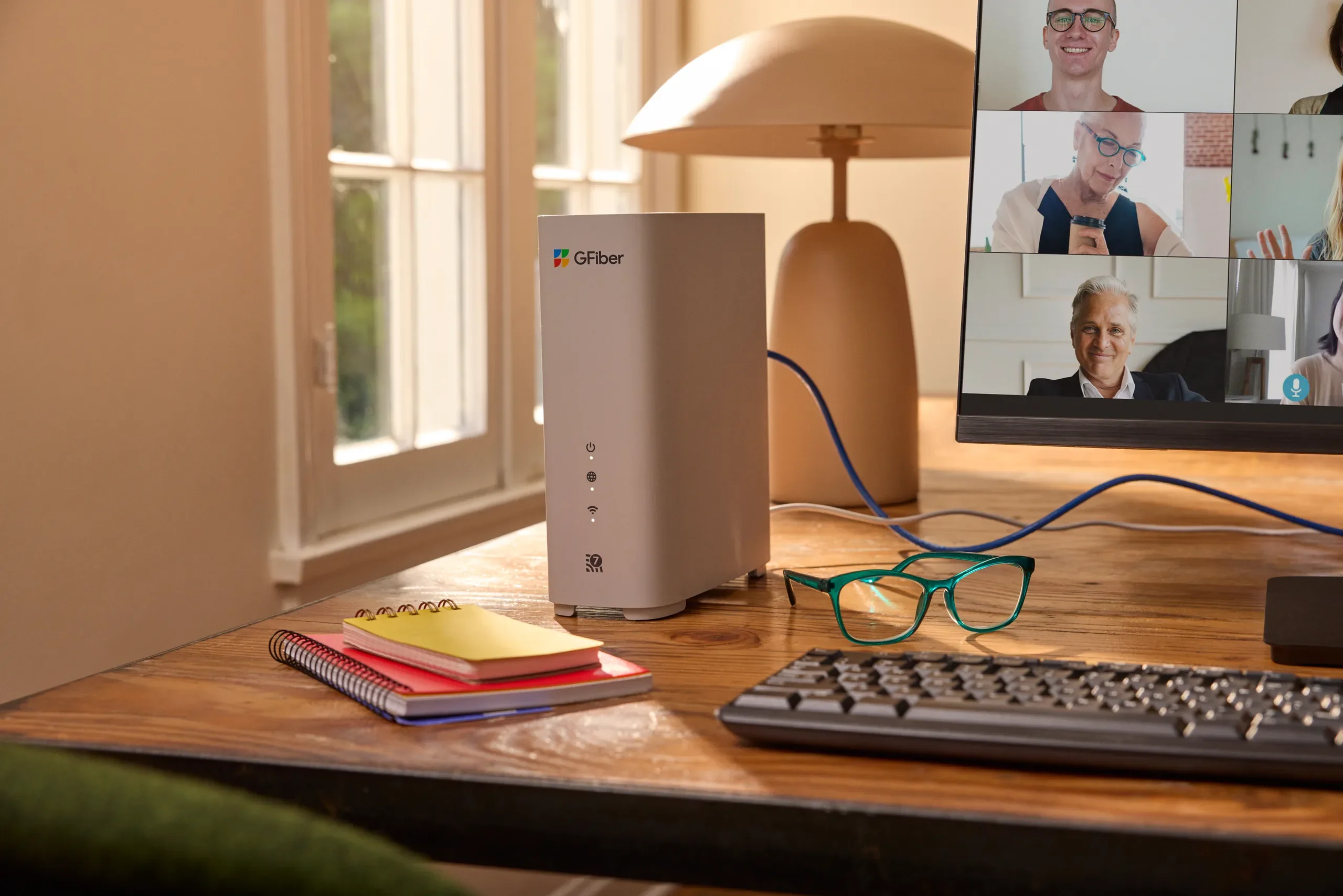 Google Fiber device on table with computer monitor and keyboard