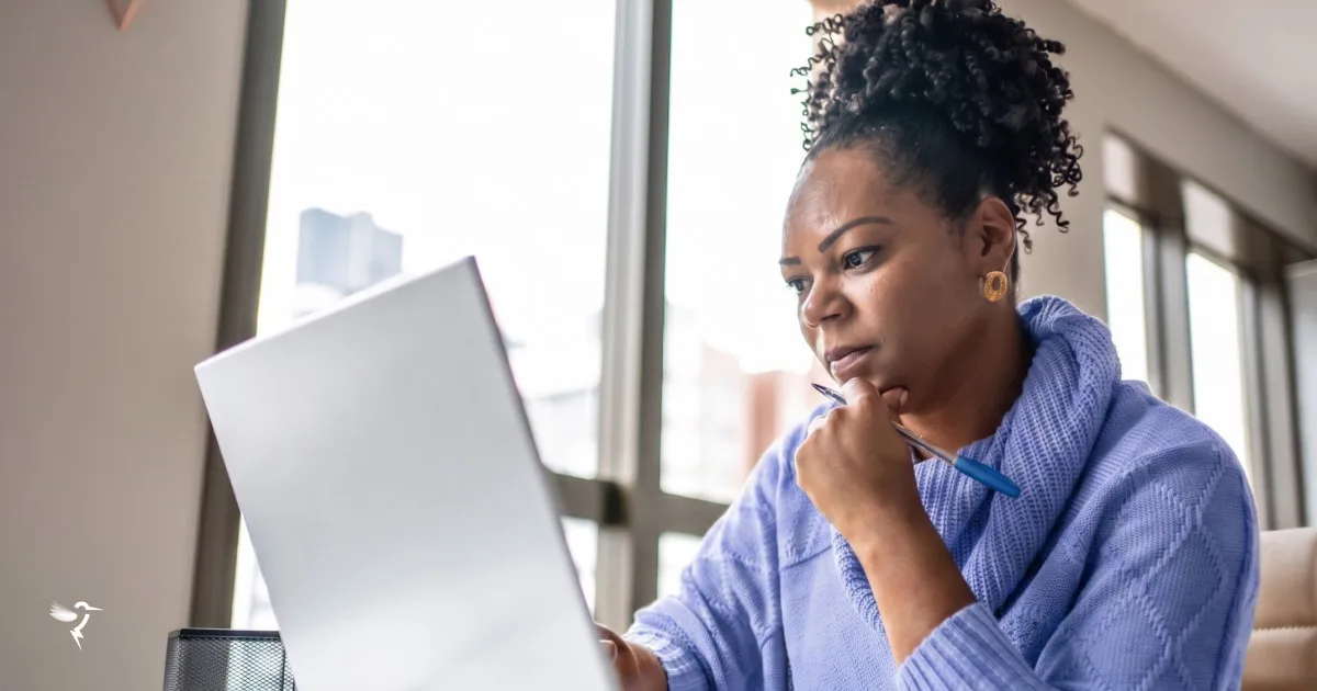 A woman looking at her laptop screen, evaluating internet usage details