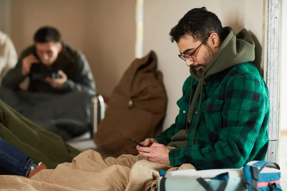 Man text messaging family during a natural disaster evacuation.
